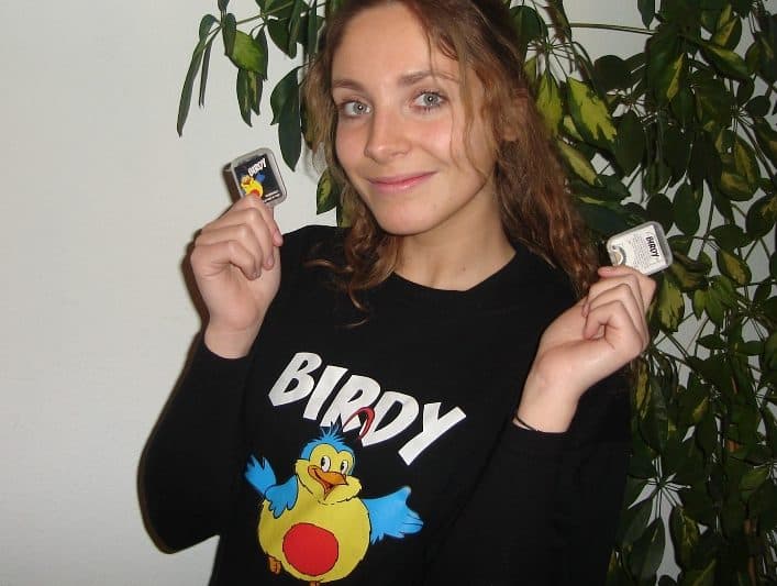 Woman holding Birdy Whistles and smiling
